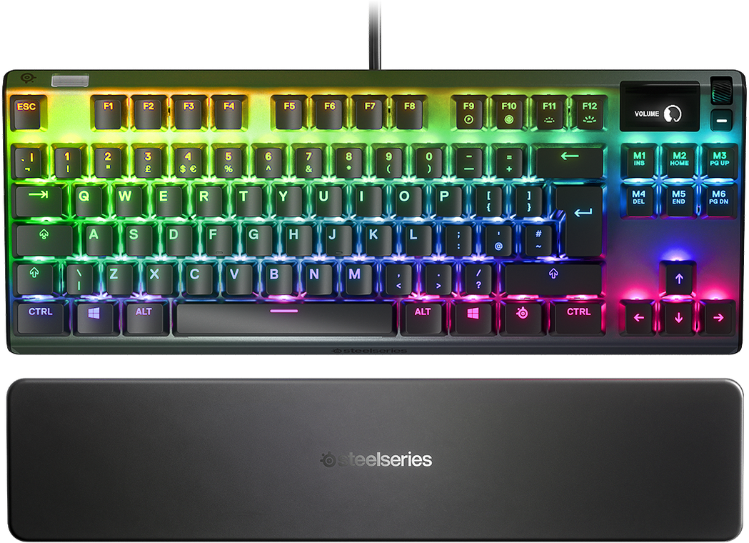 Háttérvilágításos mechanikus billentyűzet szivárvány színekkel. Alatta egy fekete csuklótámasz a SteelSeries logójával.