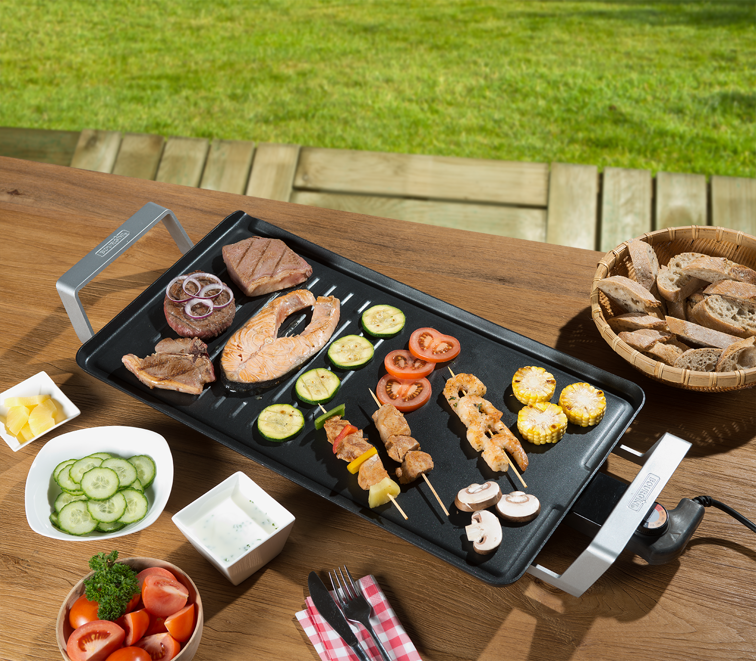 Grilled food on a table with various items: skewers, vegetables, and dipping sauces.