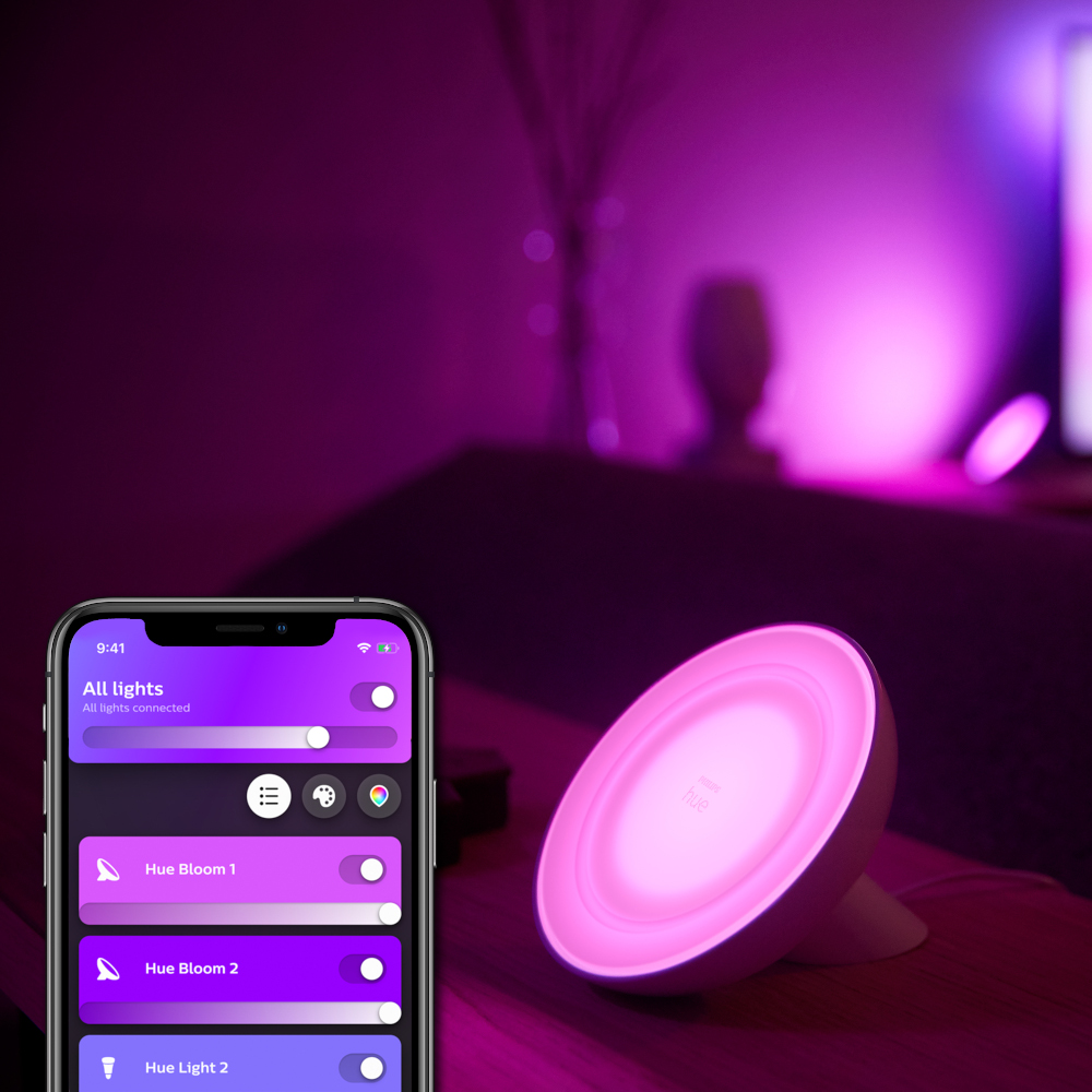 A smart lamp, showing a phone app and a pink light.