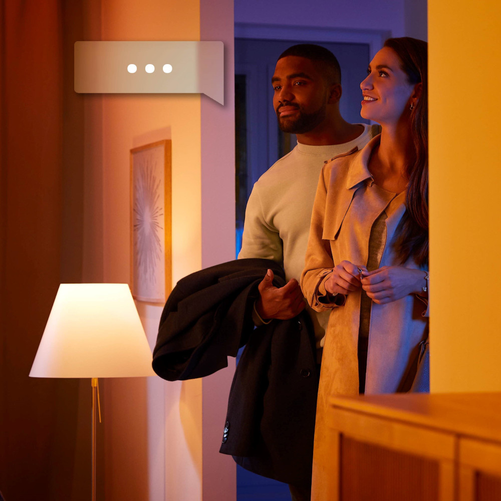 A couple in a hallway. A man and a woman are looking towards a light source.