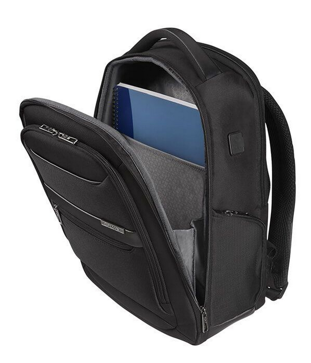 Una mochila negra para portátil abierta con un portátil y un cuaderno dentro.