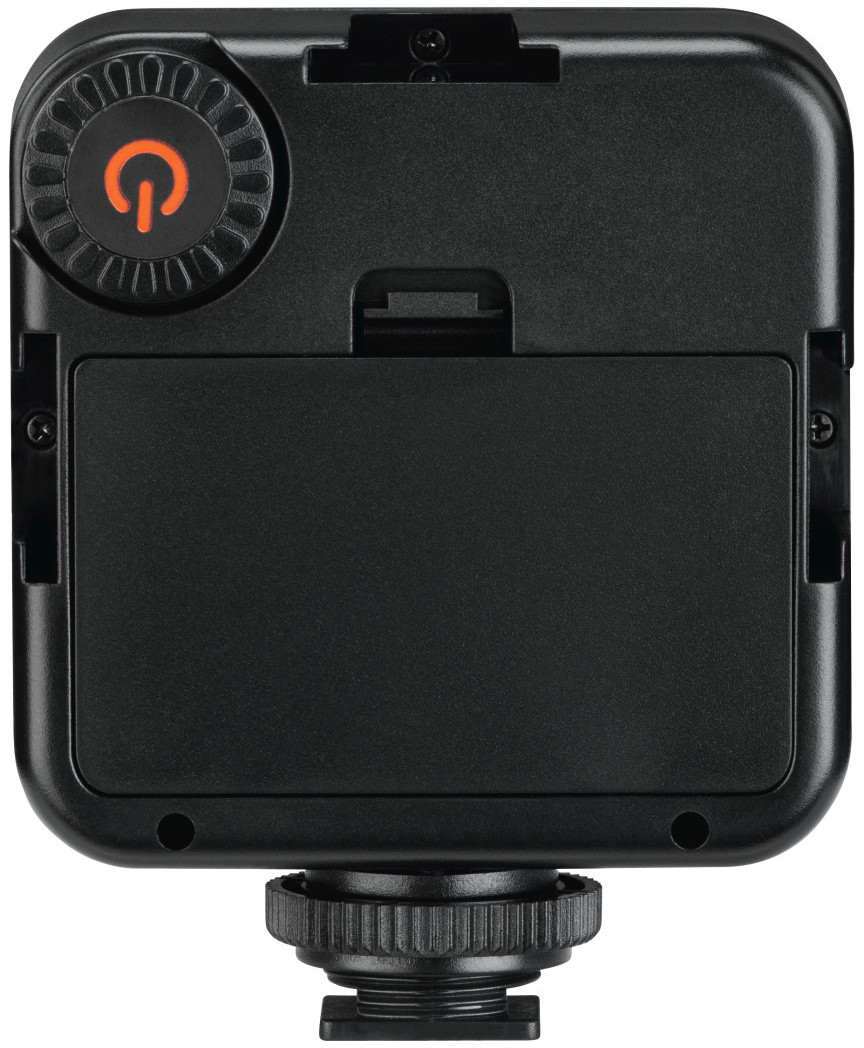 A black device with an orange power button. It has a battery compartment at the back.
