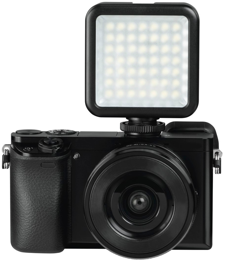 Black camera with an LED light attached, on a white background.