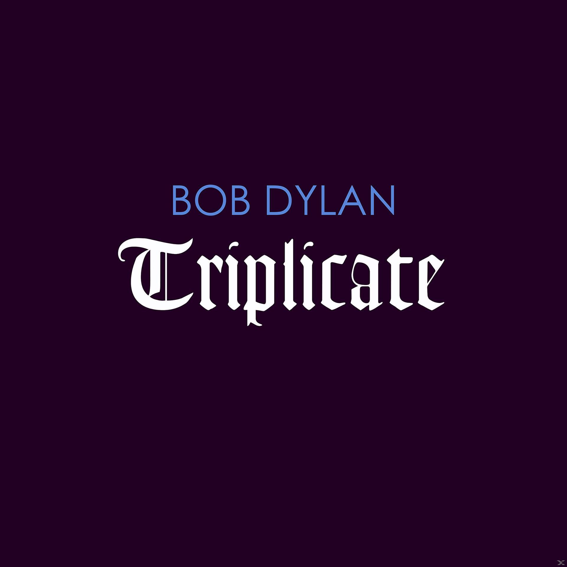 Albumcover mit Bob Dylans Namen und dem Albumtitel 'Triplicate' auf dunklem Hintergrund.