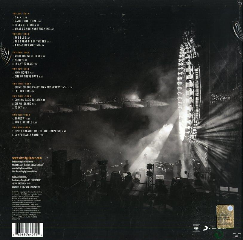 Album-Rückseite. Bühne mit Lichtern und Band-Silhouetten. Text und Trackliste auf der Rückseite.