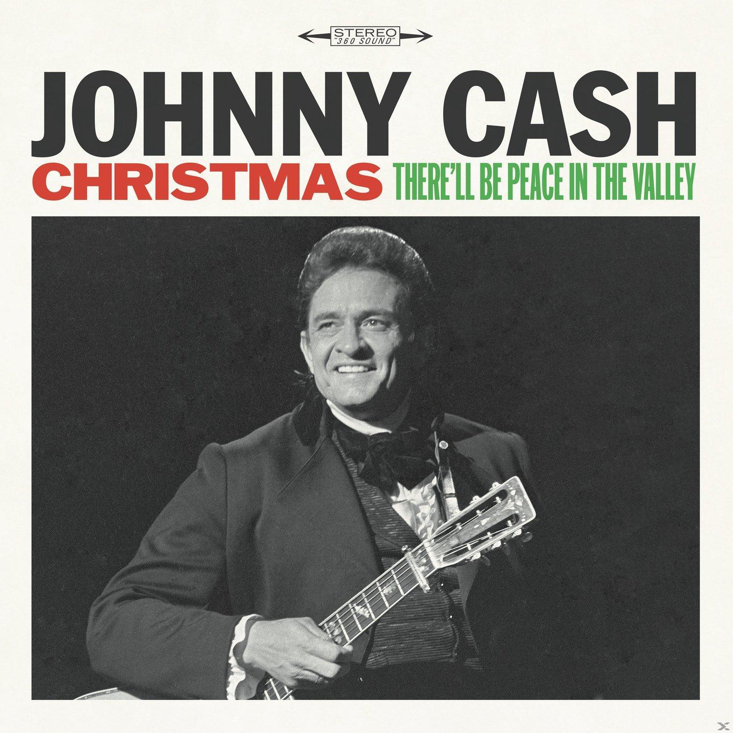 Johnny Cash album borítója. Johnny Cash fekete öltönyben van, gitárral. A cím: Karácsony.