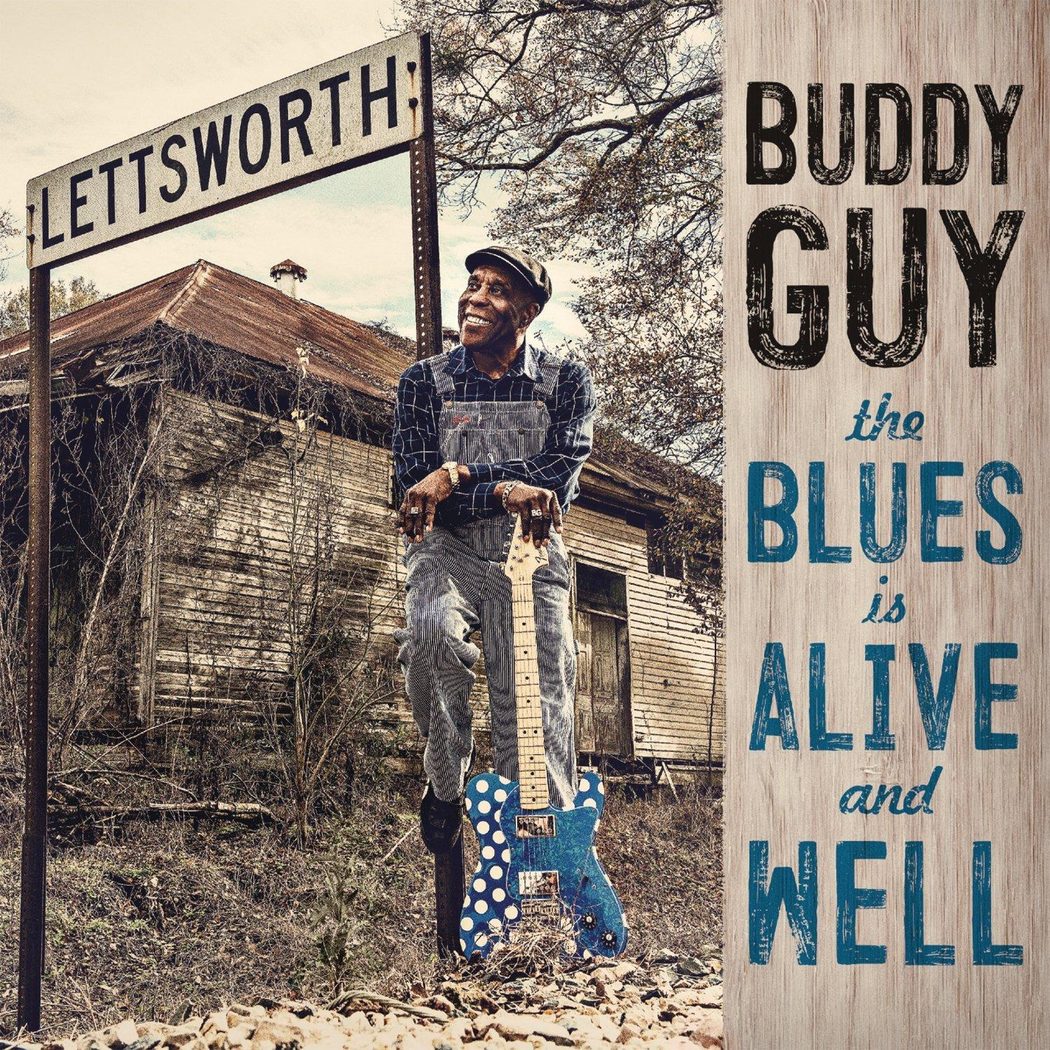 Albumcover: Buddy Guy mit einer Gitarre vor einem Holzschild und einem Haus.
