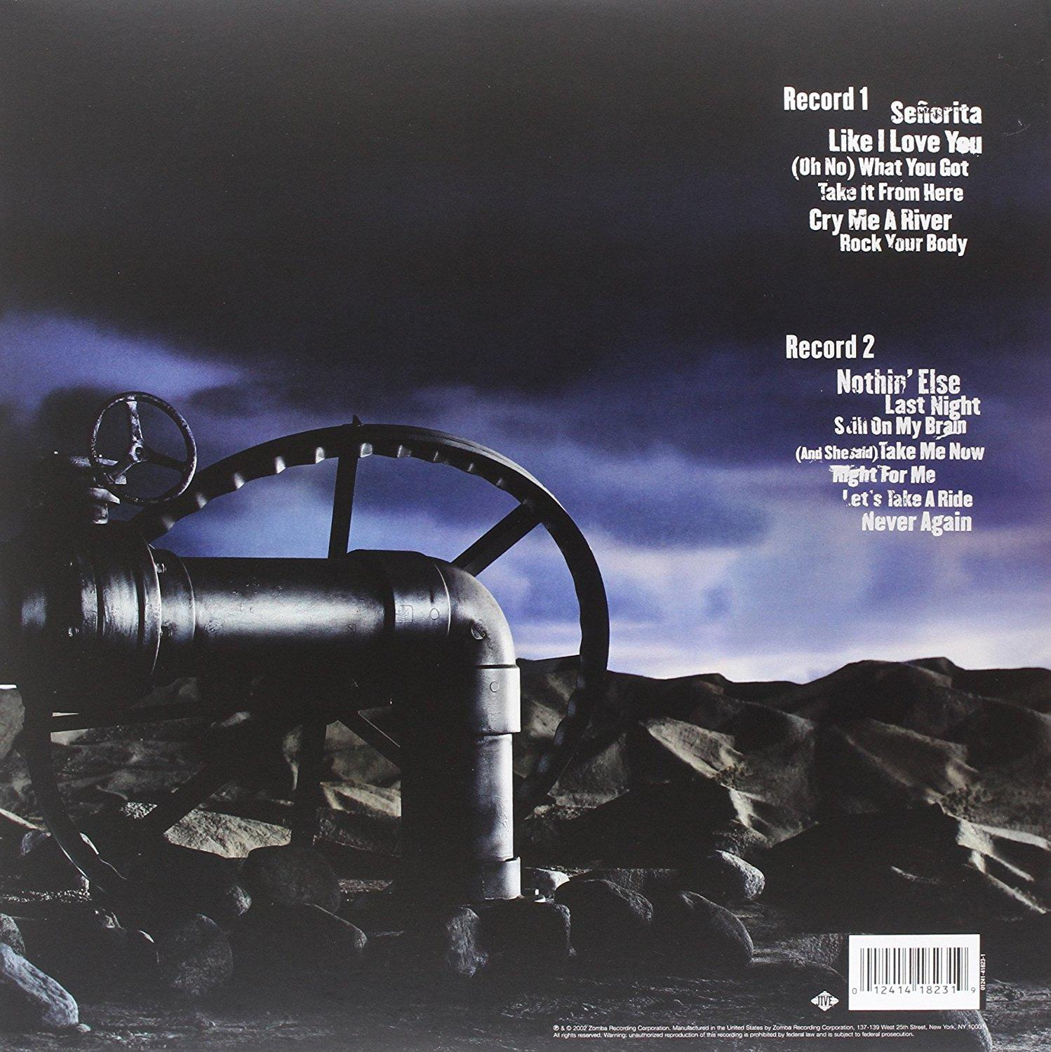 Albumcover mit mechanischer Szene. Zwei große Räder, Rohre. Songtitel oben.