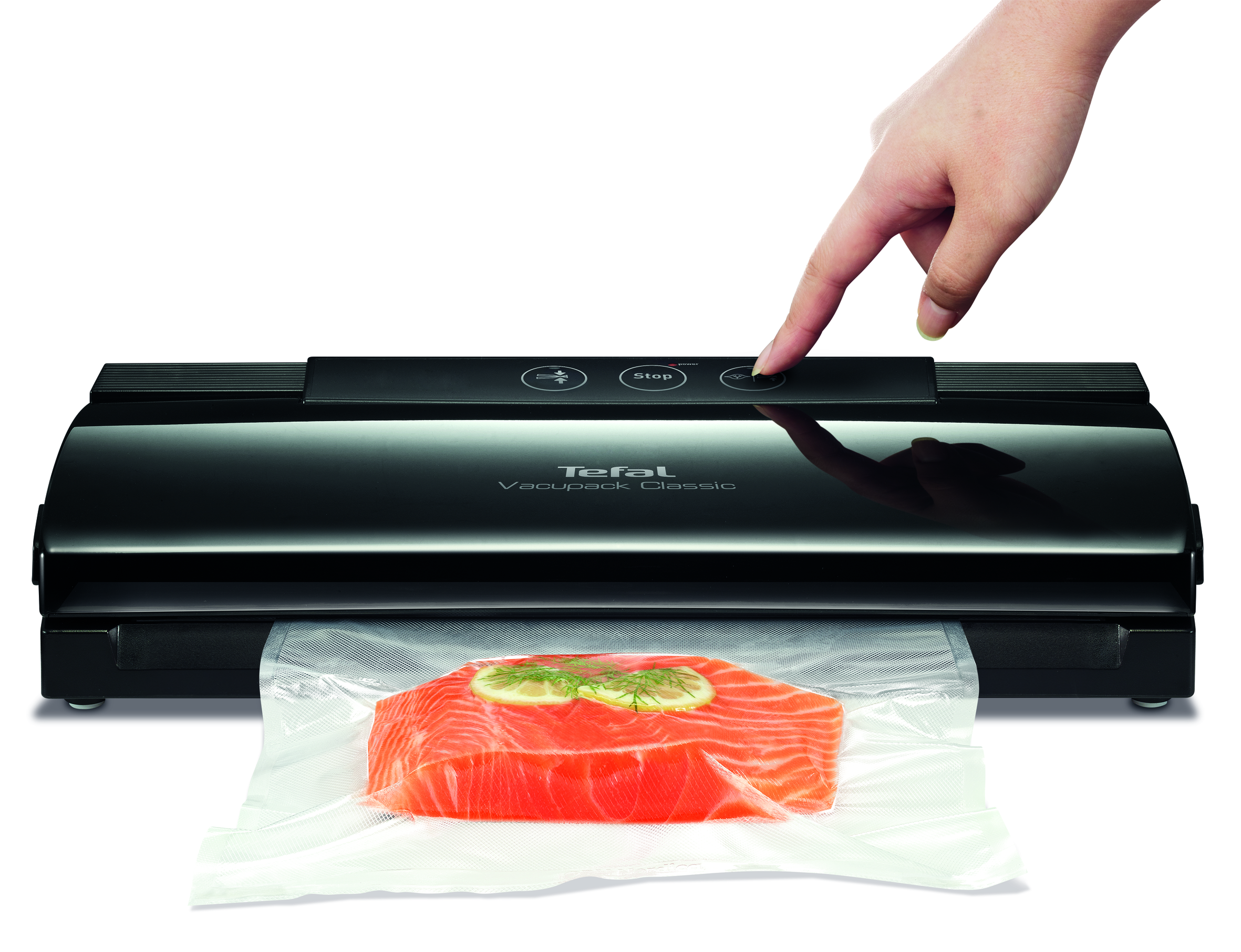 A person is pressing the stop button on a food sealer.