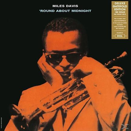 Album borítója. Miles Davis napszemüvegben trombitát tart, narancs és fekete háttér.