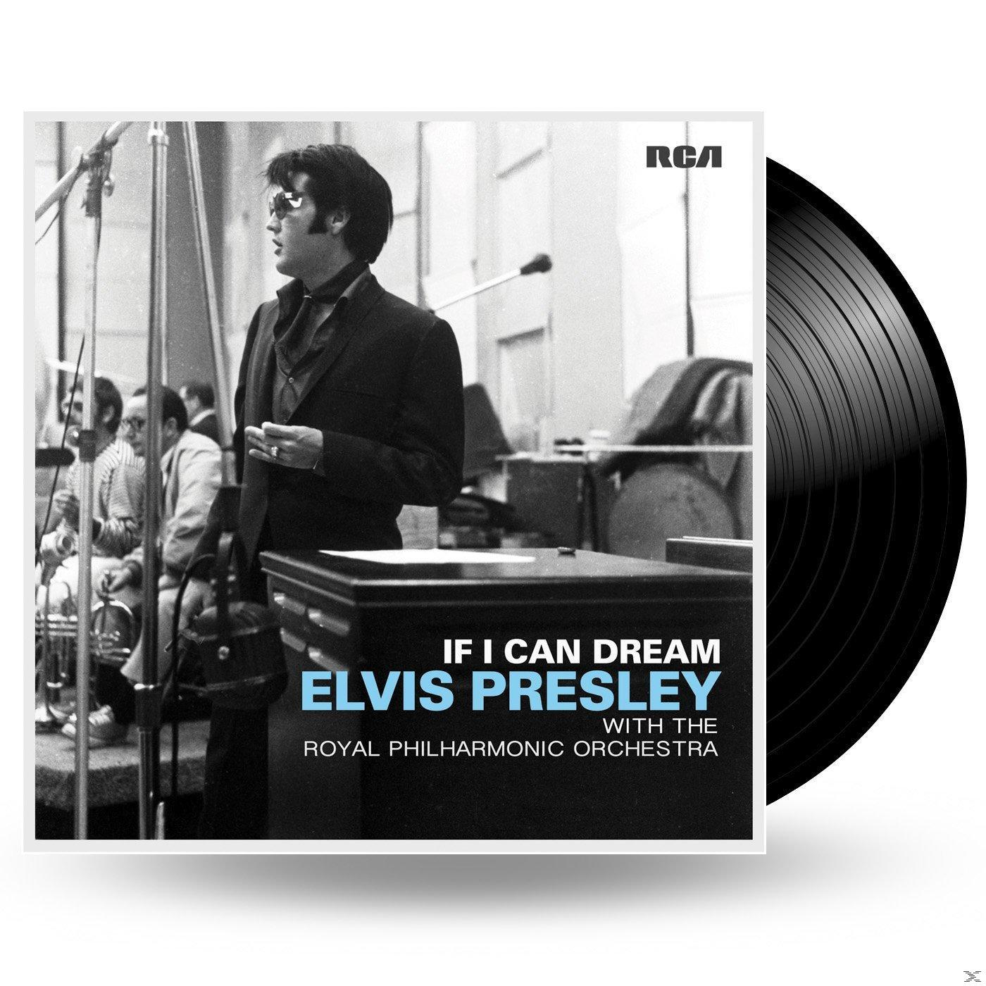 Elvis Presley öltönyben és napszemüvegben a színpadon, egy lemezborítóval és egy bakelit lemezzel.