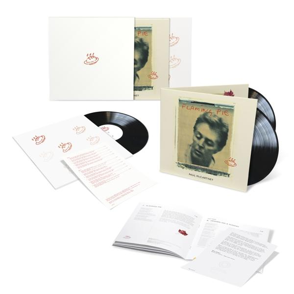 Een verzameling vinylplaten, albumhoezen en boekjes op een witte achtergrond.