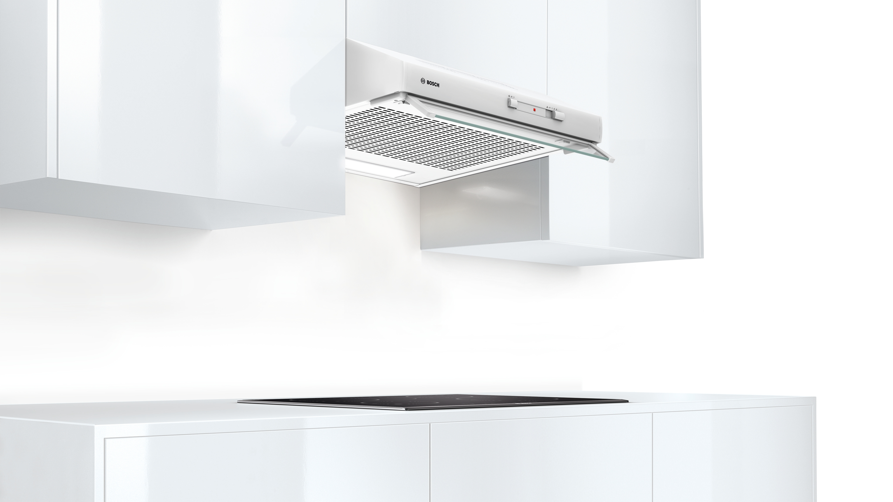 A white Bosch cooker hood installed over a hob.