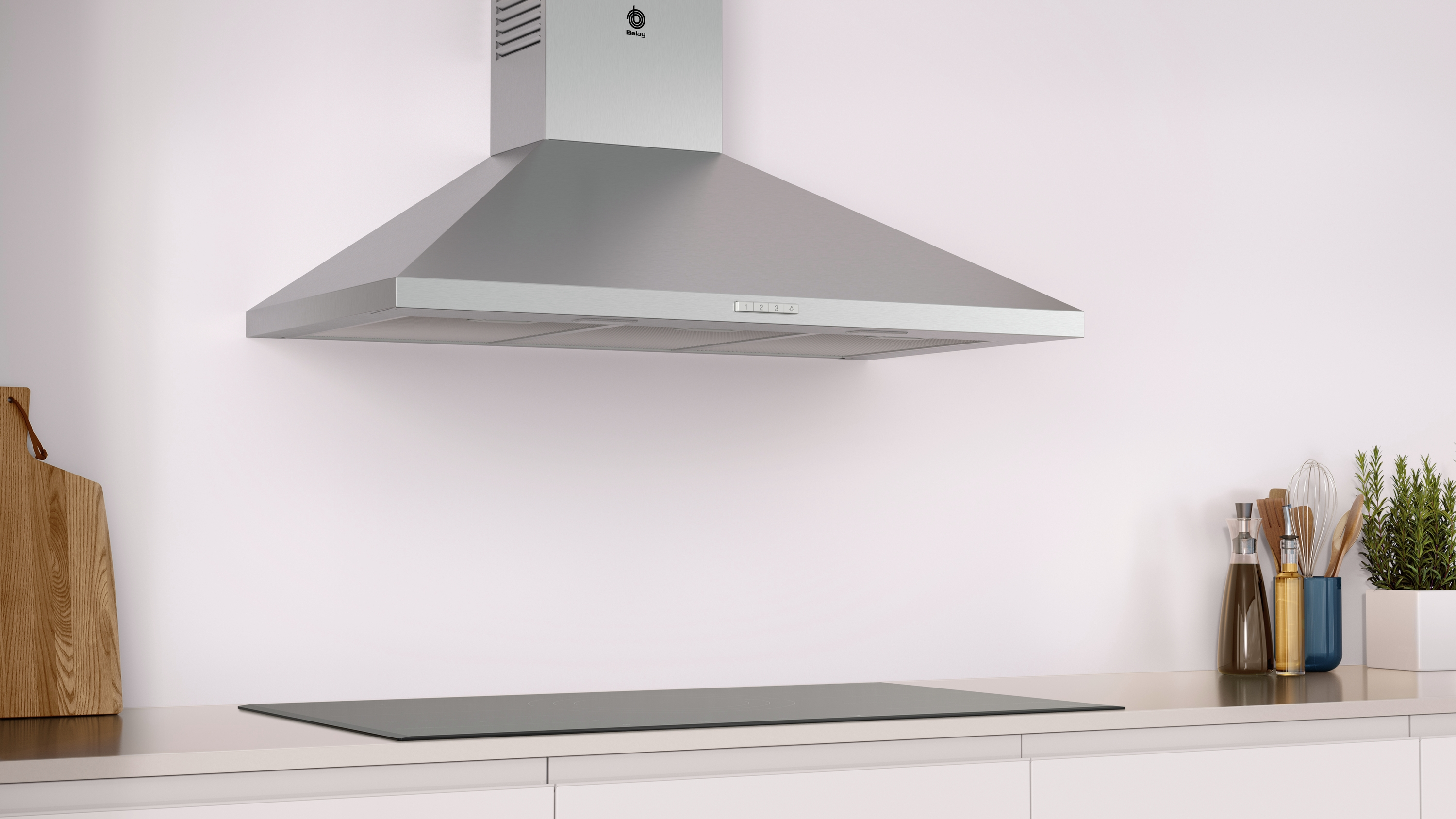Campana extractora de acero inoxidable sobre una encimera de vidrio en una cocina moderna.