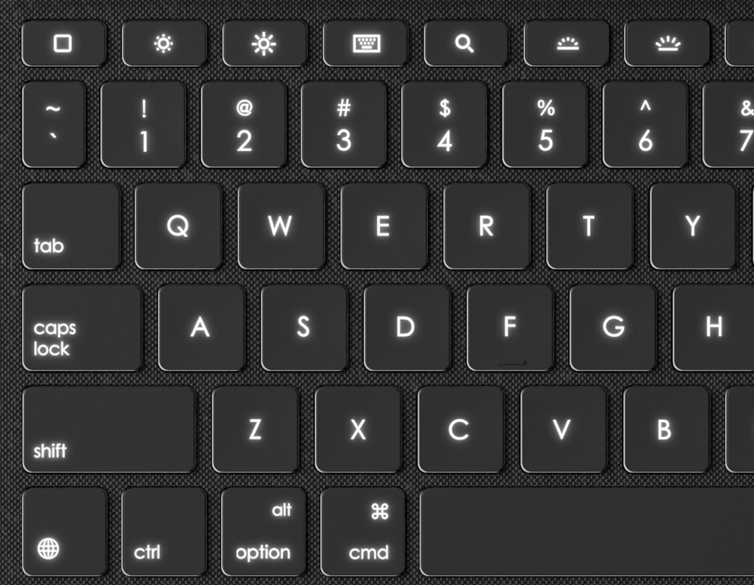 Close-up of a laptop keyboard with illuminated keys. Dark background and the keyboard is black.