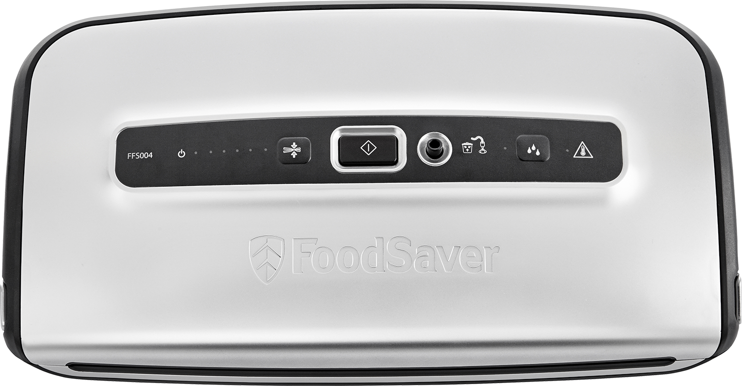 Silver FoodSaver vacuum sealer. The top has buttons and a logo. The surface is reflective and glossy.