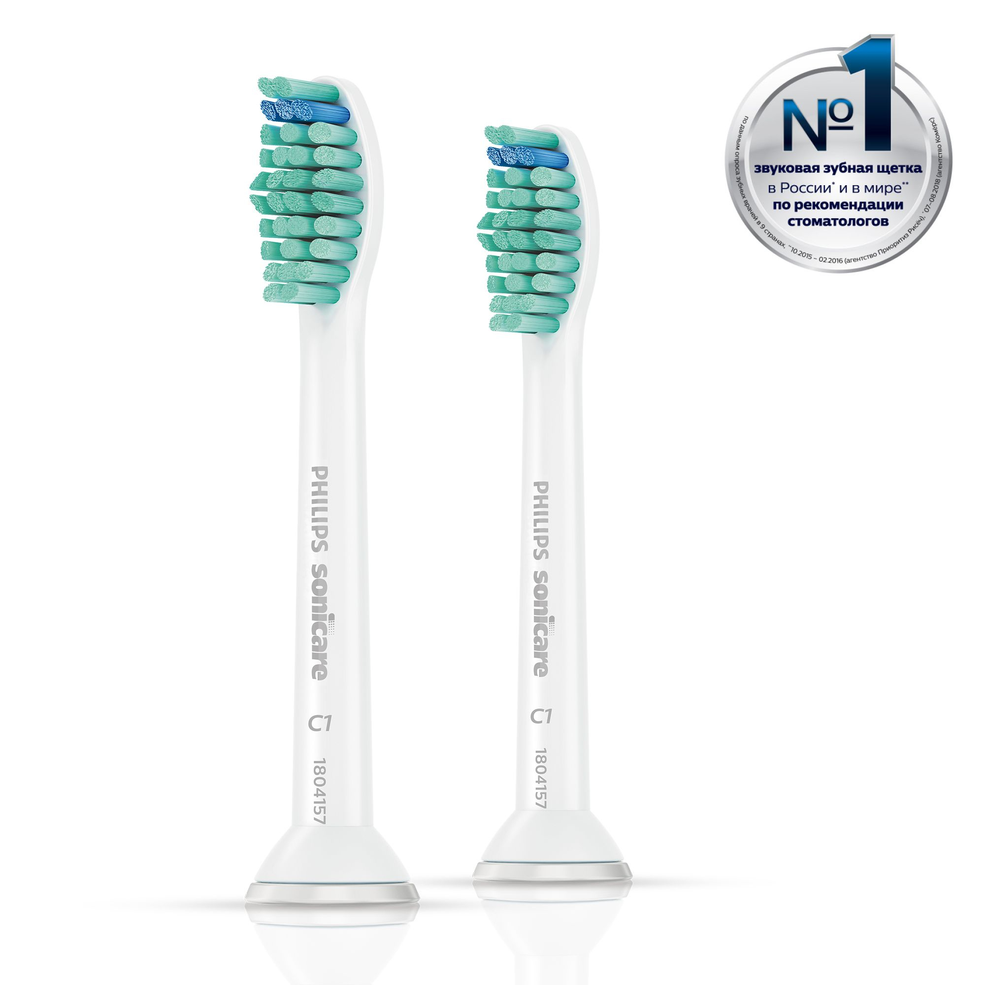 Two white Philips Sonicare toothbrush heads with green and blue bristles, angled towards the viewer.