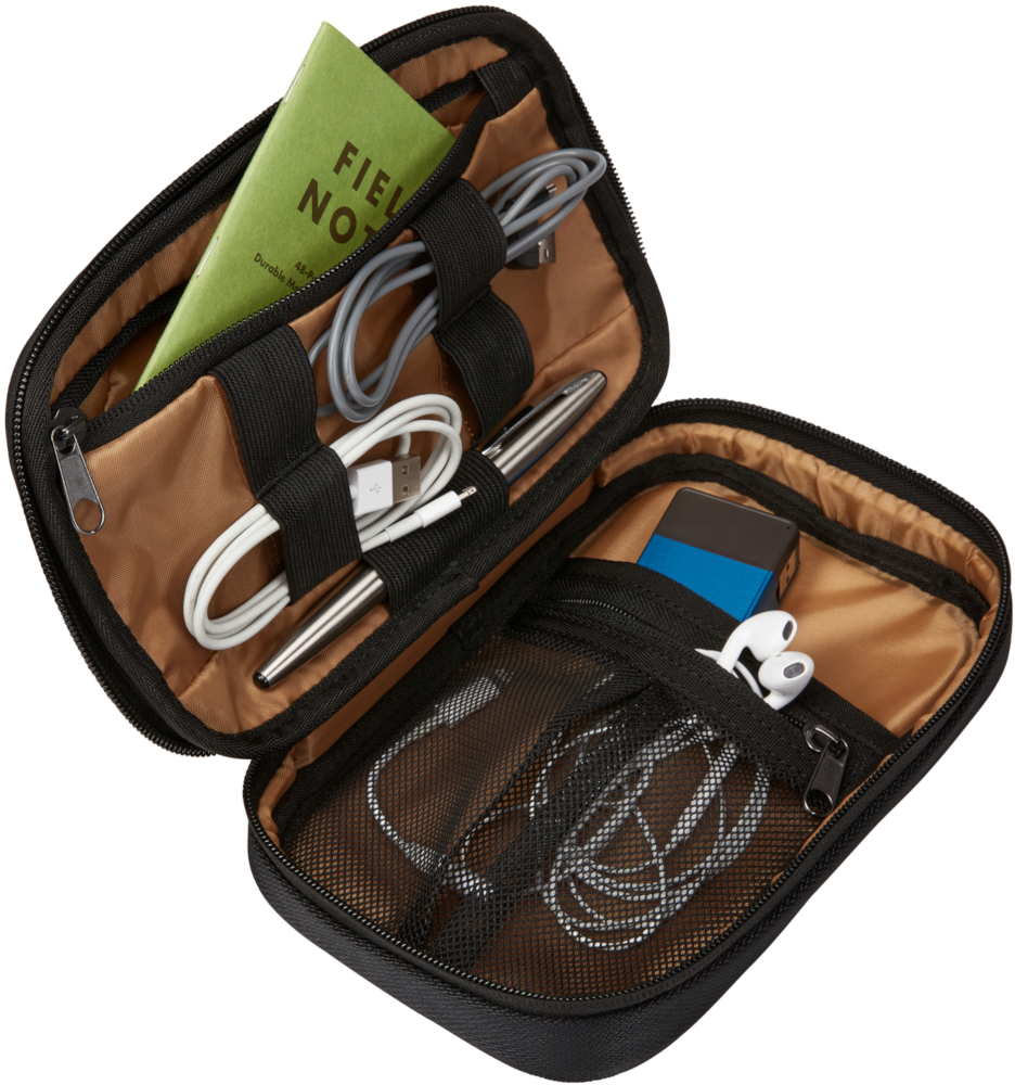 Open organizer with cables, pen, notepad, and other items. Brown and black.