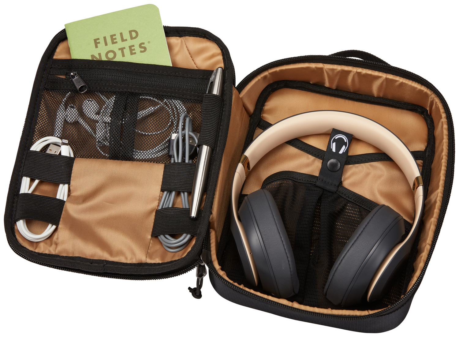 Open tech travel case with headphones, cables, pen, and notebook, on a white background.