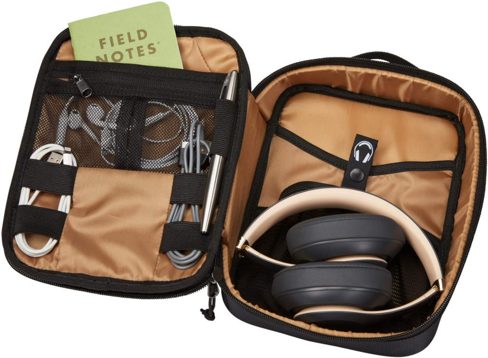 Open black travel case with headphones, notepad, cables and pen.