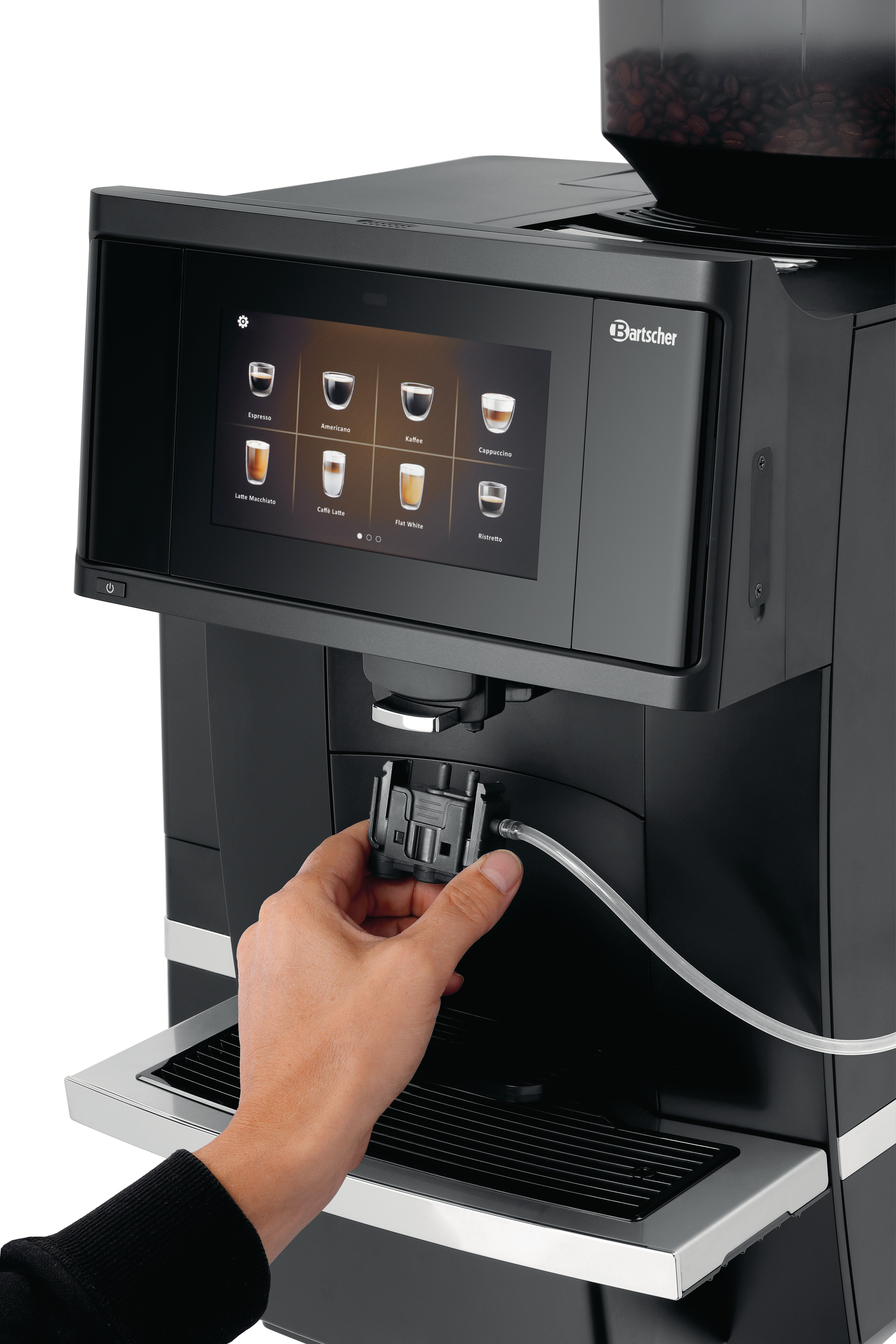 Eine Hand hält ein Teil eines Kaffeeautomaten mit Touchscreen-Menü.
