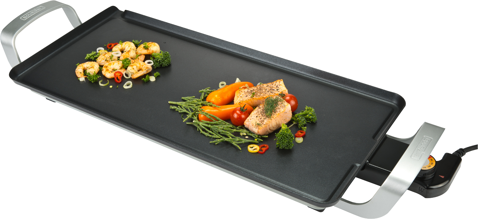 An electric griddle with cooked shrimp, vegetables, and salmon.