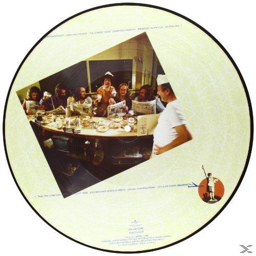 Vinyl record with a photograph of people at a table, and text around the circle.