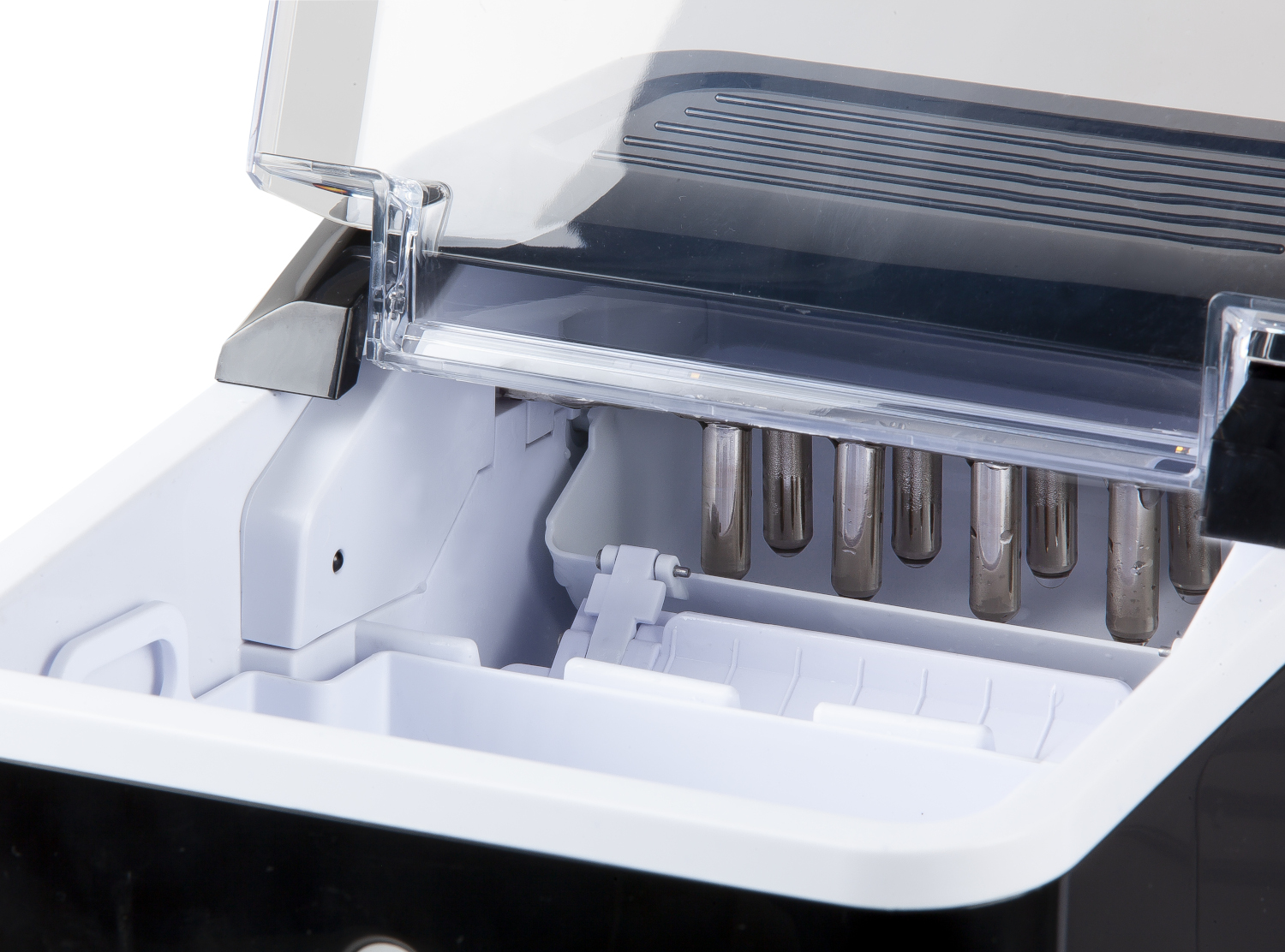 Open ice maker showing the interior with ice-making components.