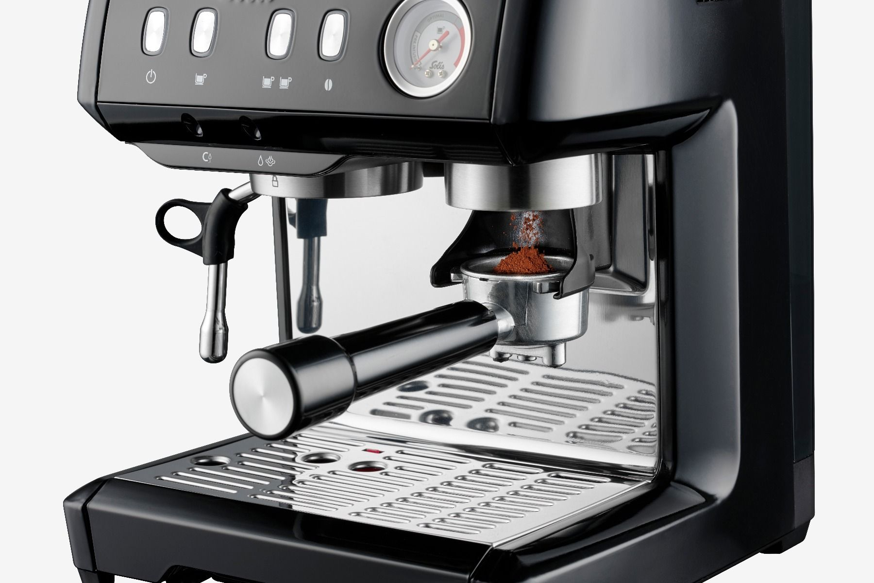 Black espresso machine. Portafilter holds coffee grounds. Silver tray and buttons visible.