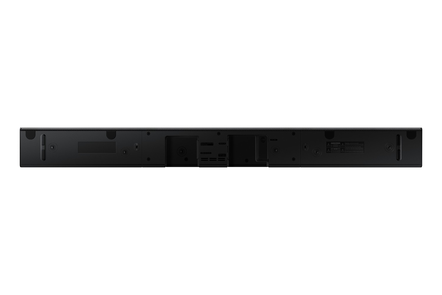 Barra de sonido negra, vista trasera. Contiene varios puertos de entrada y etiquetas informativas. Fondo blanco.