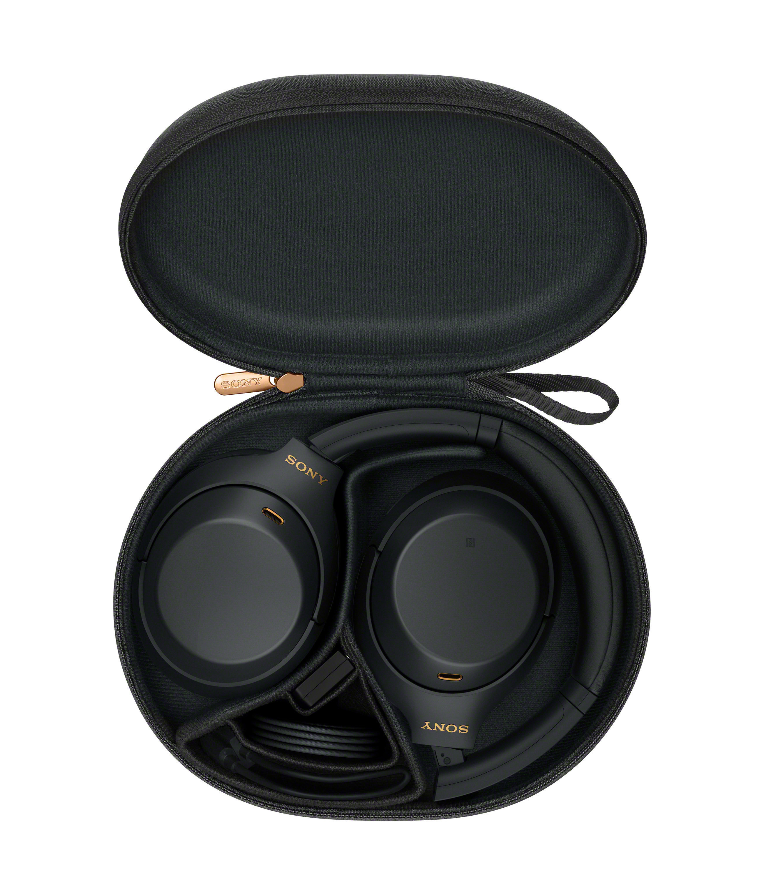 Schwarze Kopfhörer in einer schwarzen Tragetasche. Die Tasche ist oval, und die Kopfhörer sind darin gefaltet.