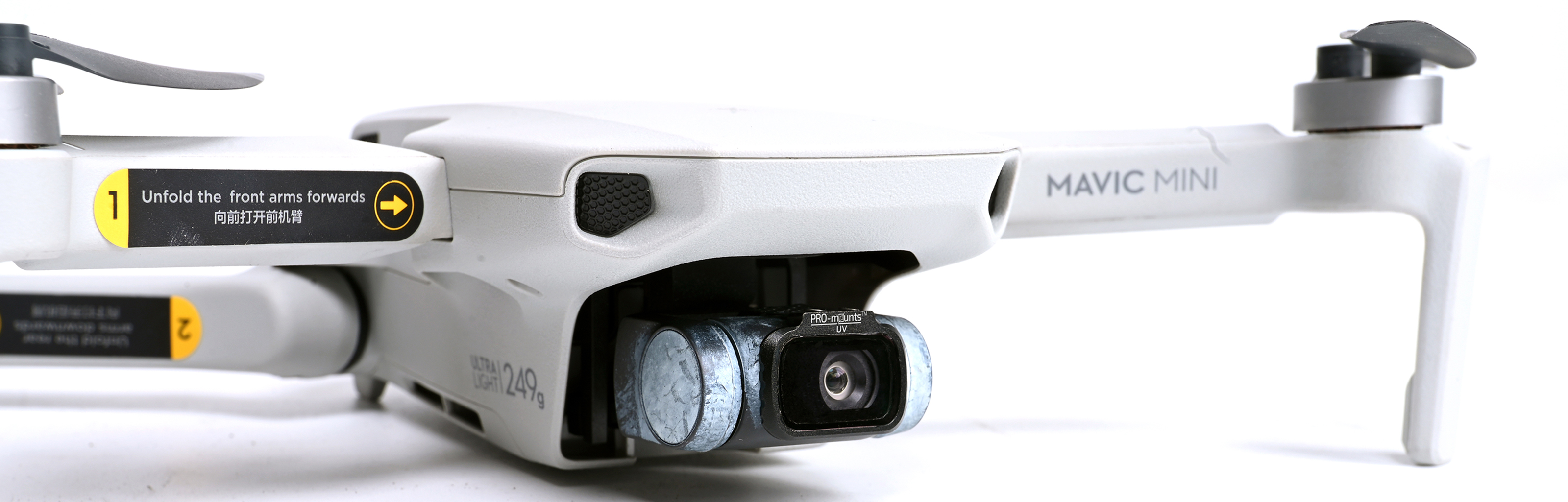 White drone with camera and propellers, text: Mavic Mini.