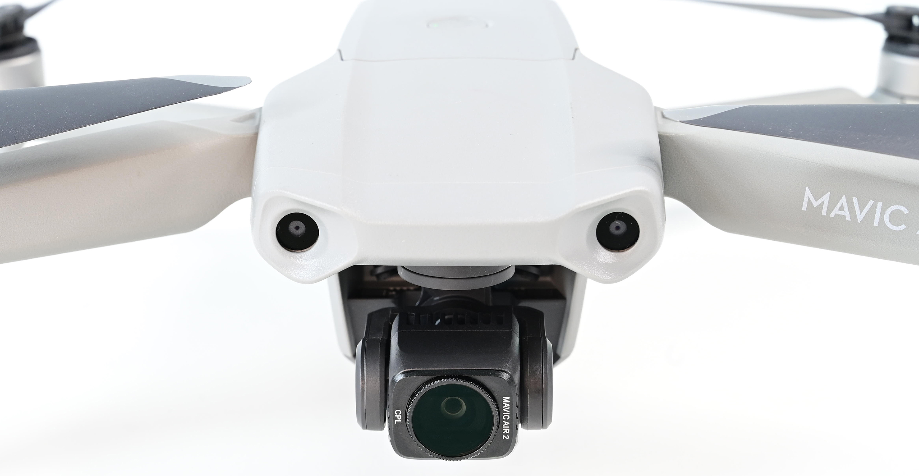 A drone from a top view, with a camera and two propellers, white background.