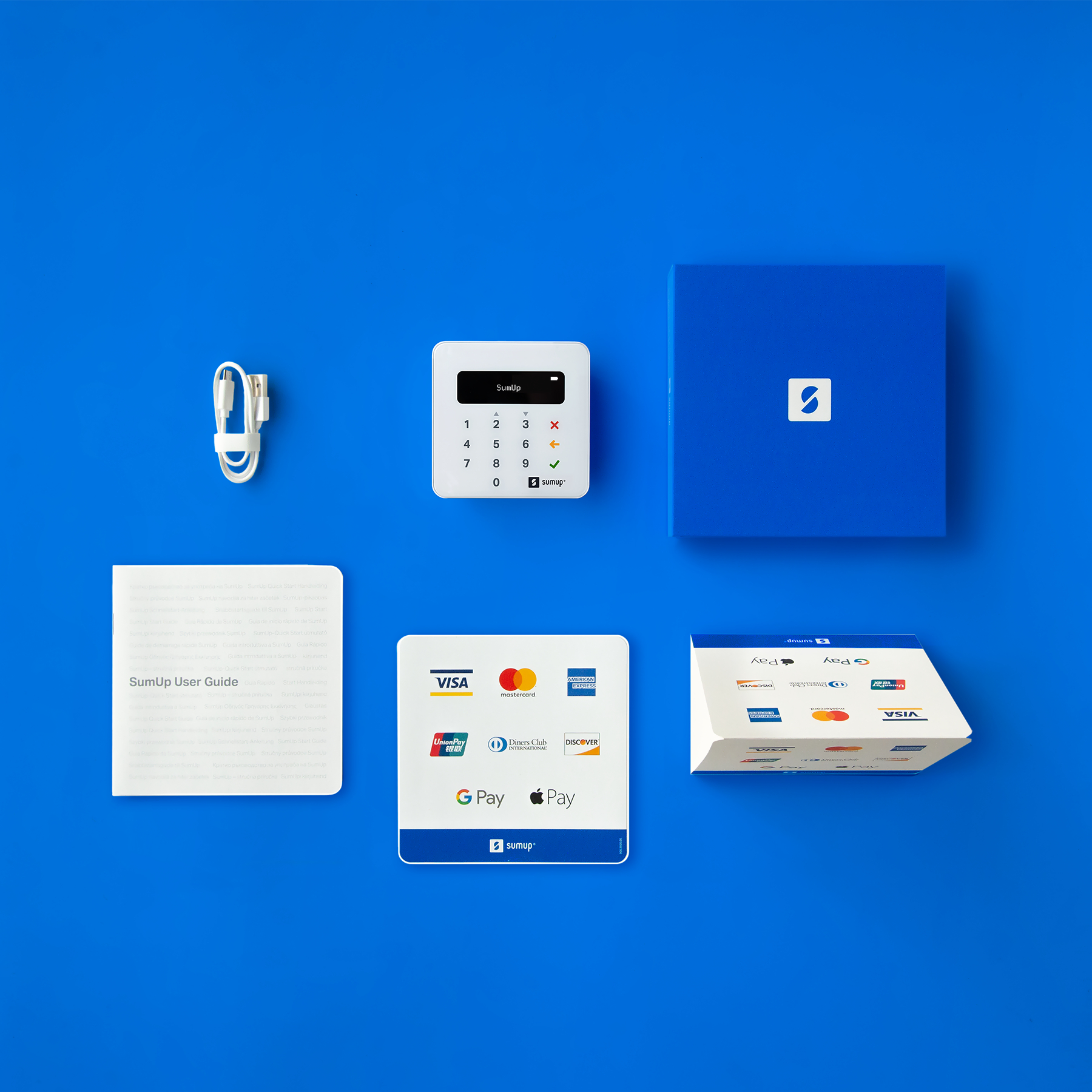 Draufsicht auf Zahlungsgerät, Box, Kabel, Benutzerhandbuch und Karten.