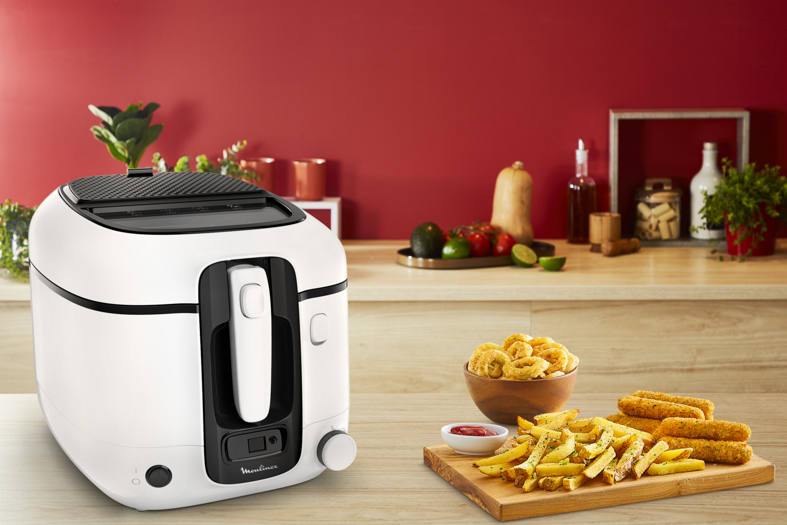 White deep fryer with food items. French fries, onion rings, and chicken nuggets are displayed.