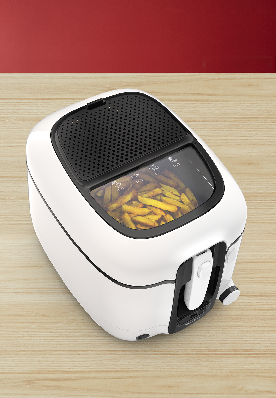 White and black air fryer with french fries inside, on a wooden table.