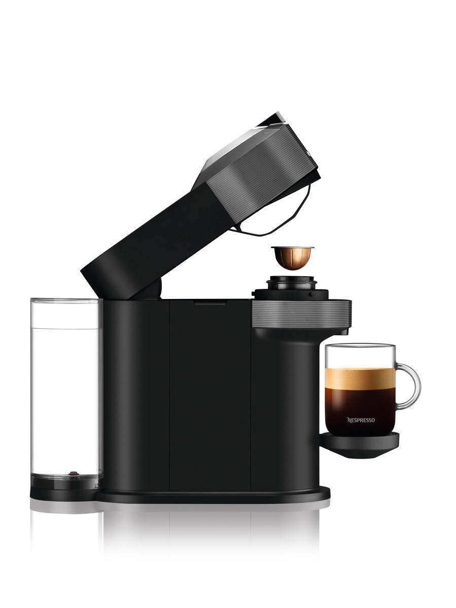 Schwarze Nespresso-Kaffeemaschine mit einer Tasse Kaffee und einem Glastank.