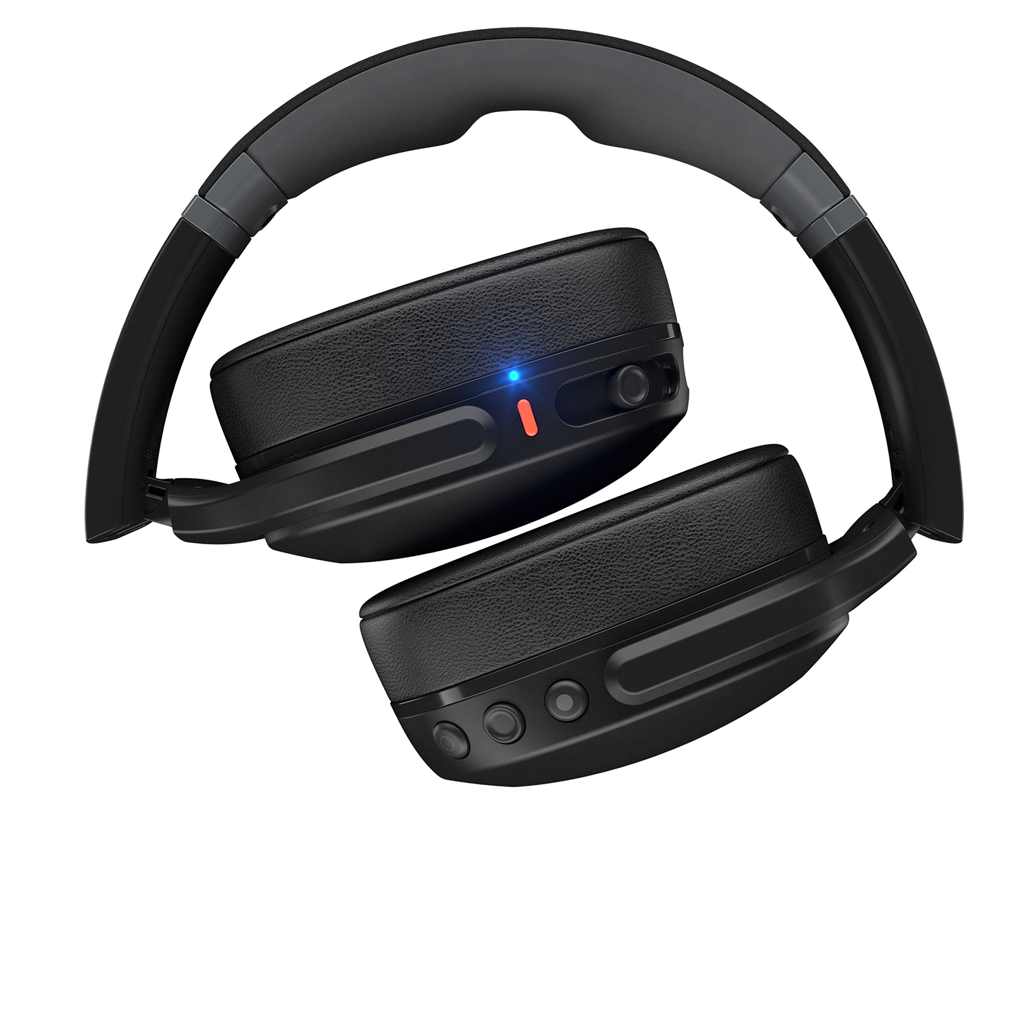 Zwarte Skullcandy-koptelefoon met grijze hoofdband, opgevouwen op witte achtergrond.