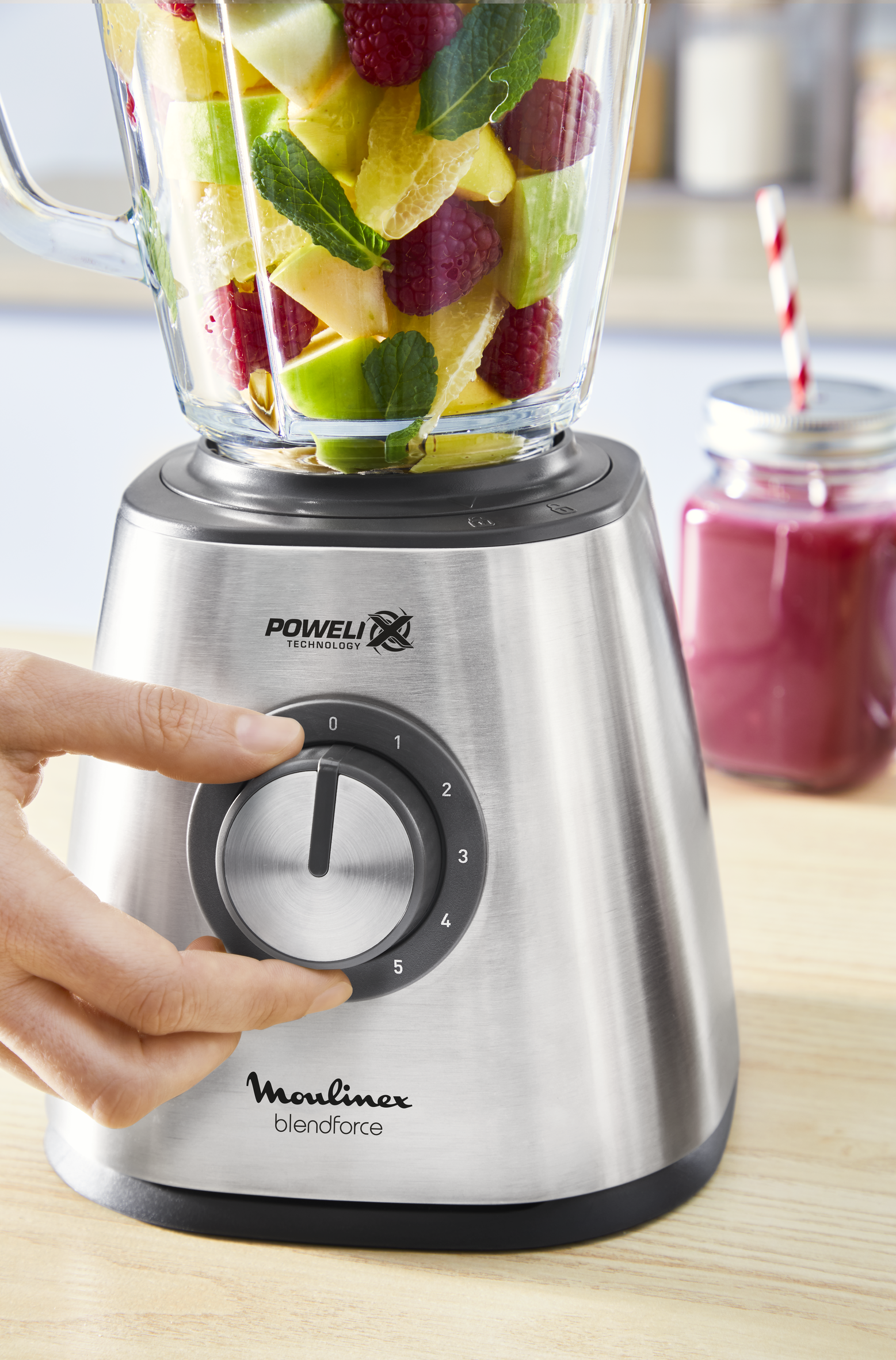 A person is using a blender.