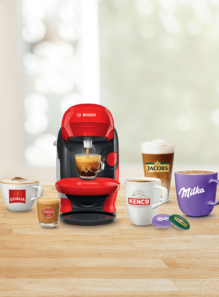 Kaffeemaschine mit Tassen und Kaffeegetränken auf einer Holzoberfläche.