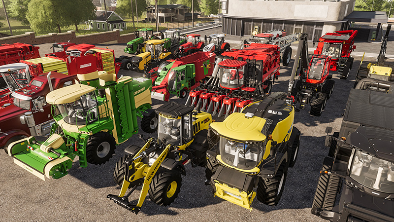 Een verzameling tractoren en landbouwmachines geparkeerd op een asfalt oppervlak.