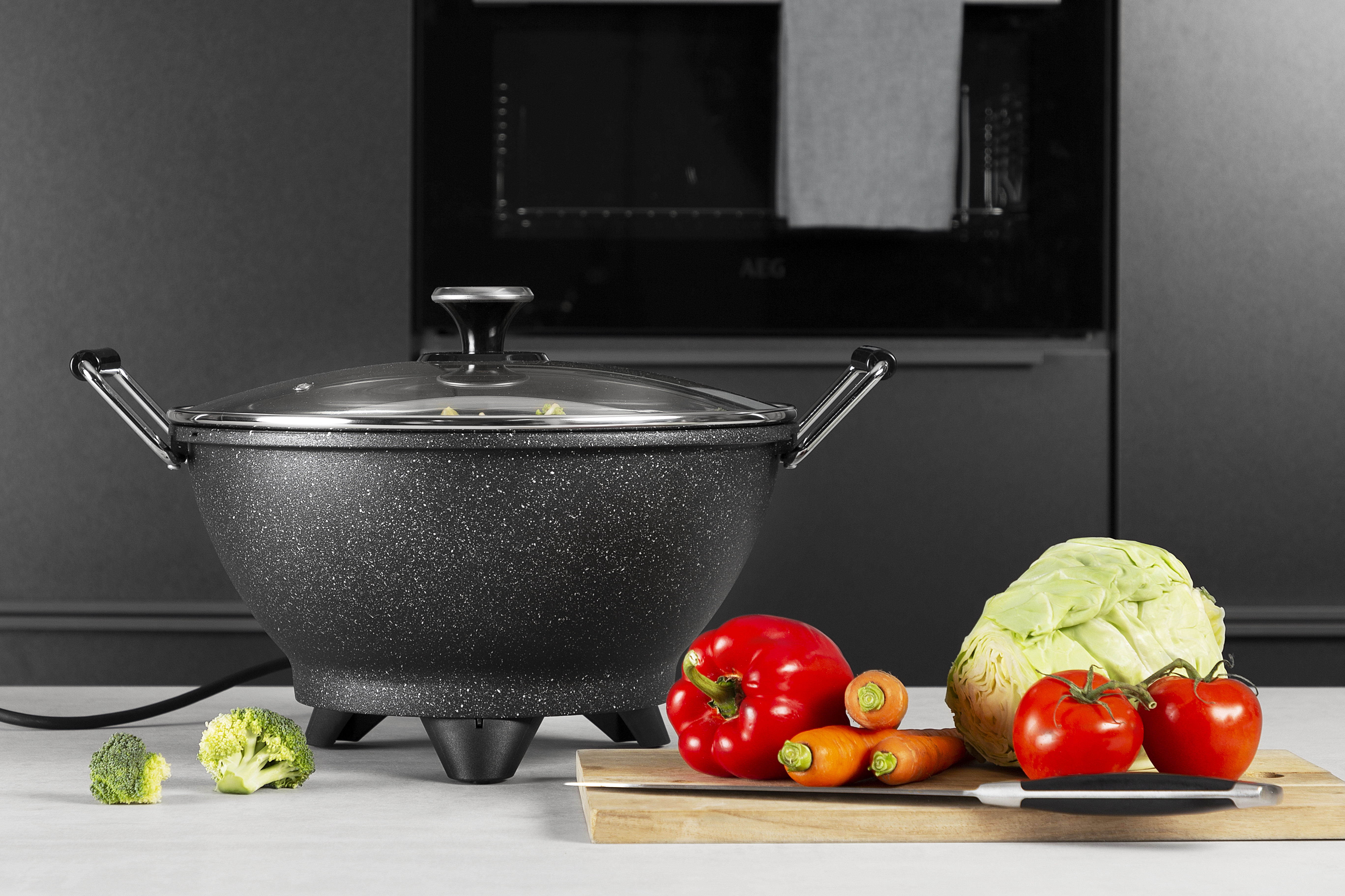 Cooking pot with vegetables. Includes red peppers, tomatoes, broccoli and carrots.