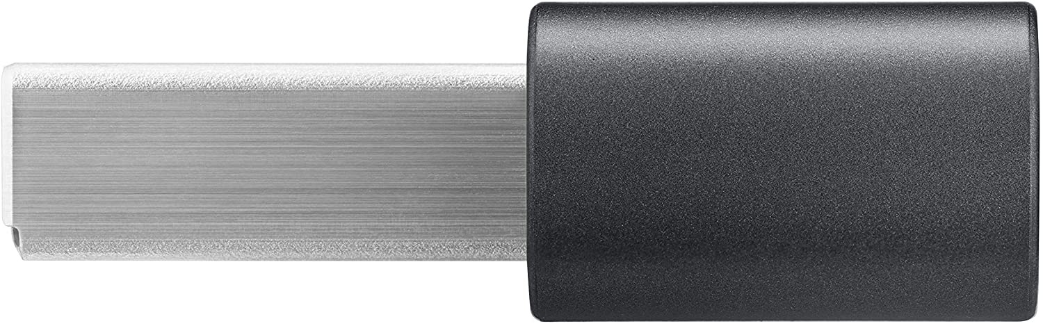 Una pieza de metal plateado conectada a un componente cilíndrico negro.