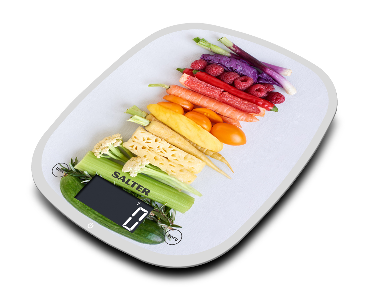 A white scale with vegetables arranged on top.