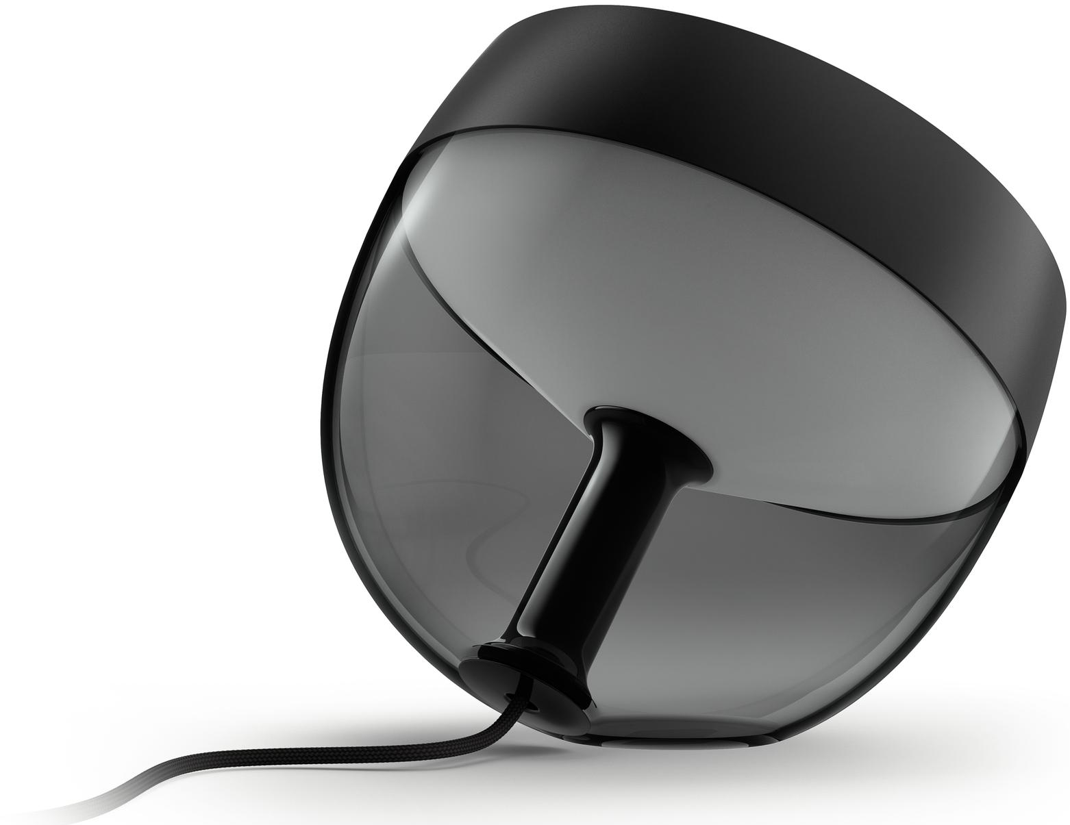 Lampe moderne noire et grise avec cordon d'alimentation, posée sur une surface blanche.