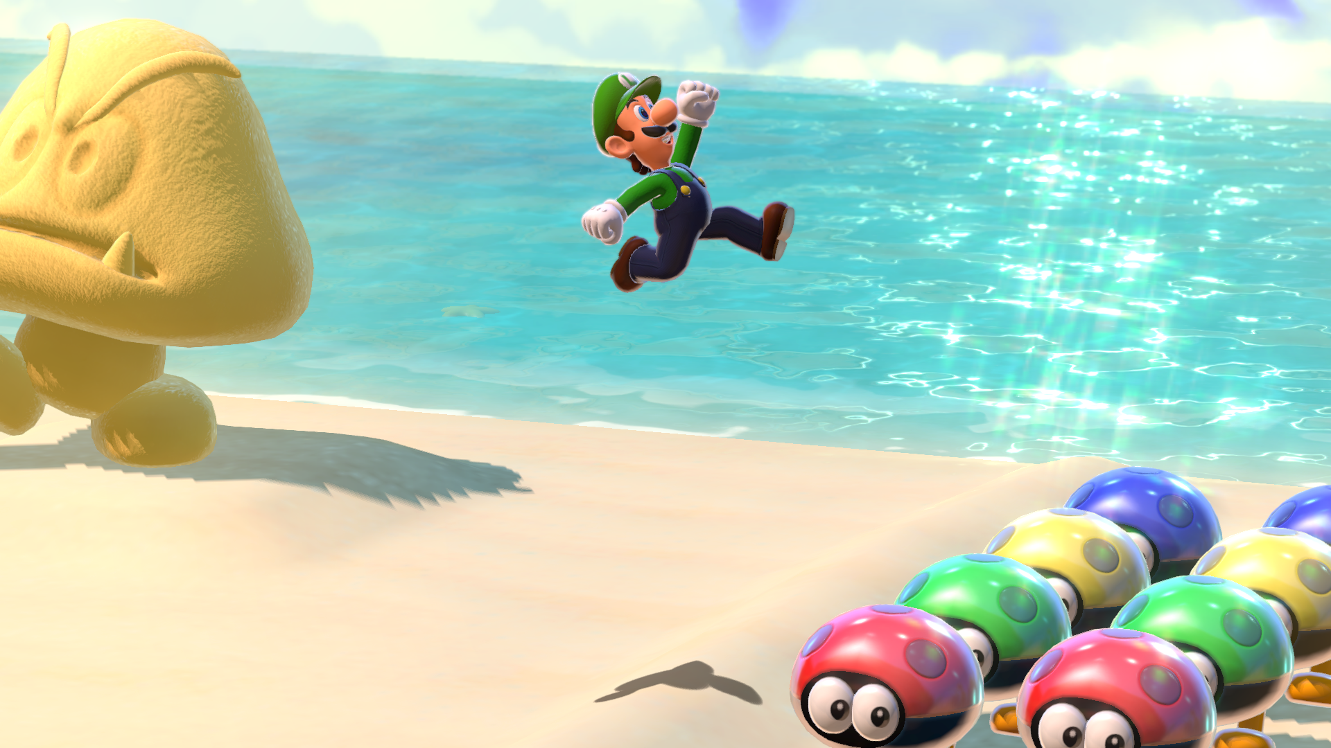 Luigi salta hacia la cámara en la playa, con un Goomba y otros Goombas.
