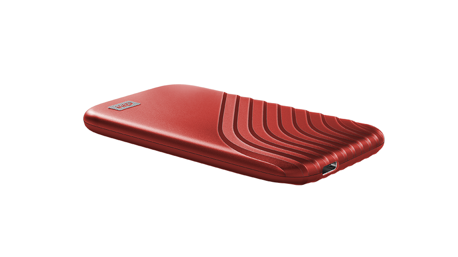 Red external hard drive on a black background. The drive has a unique design.