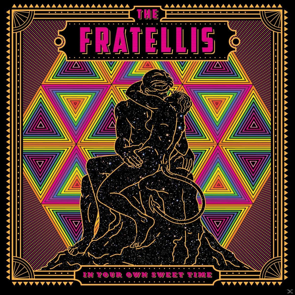 Albumcover mit einem sich umarmenden Paar vor einem bunten geometrischen Hintergrund. Text: 'The Fratellis'.