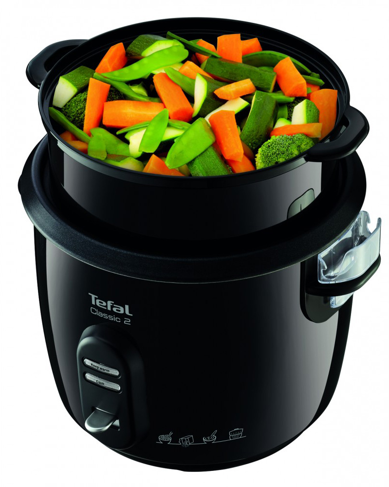 Fekete Tefal rizsfőző színes zöldségeket tartalmazó gőzölő kosárral.