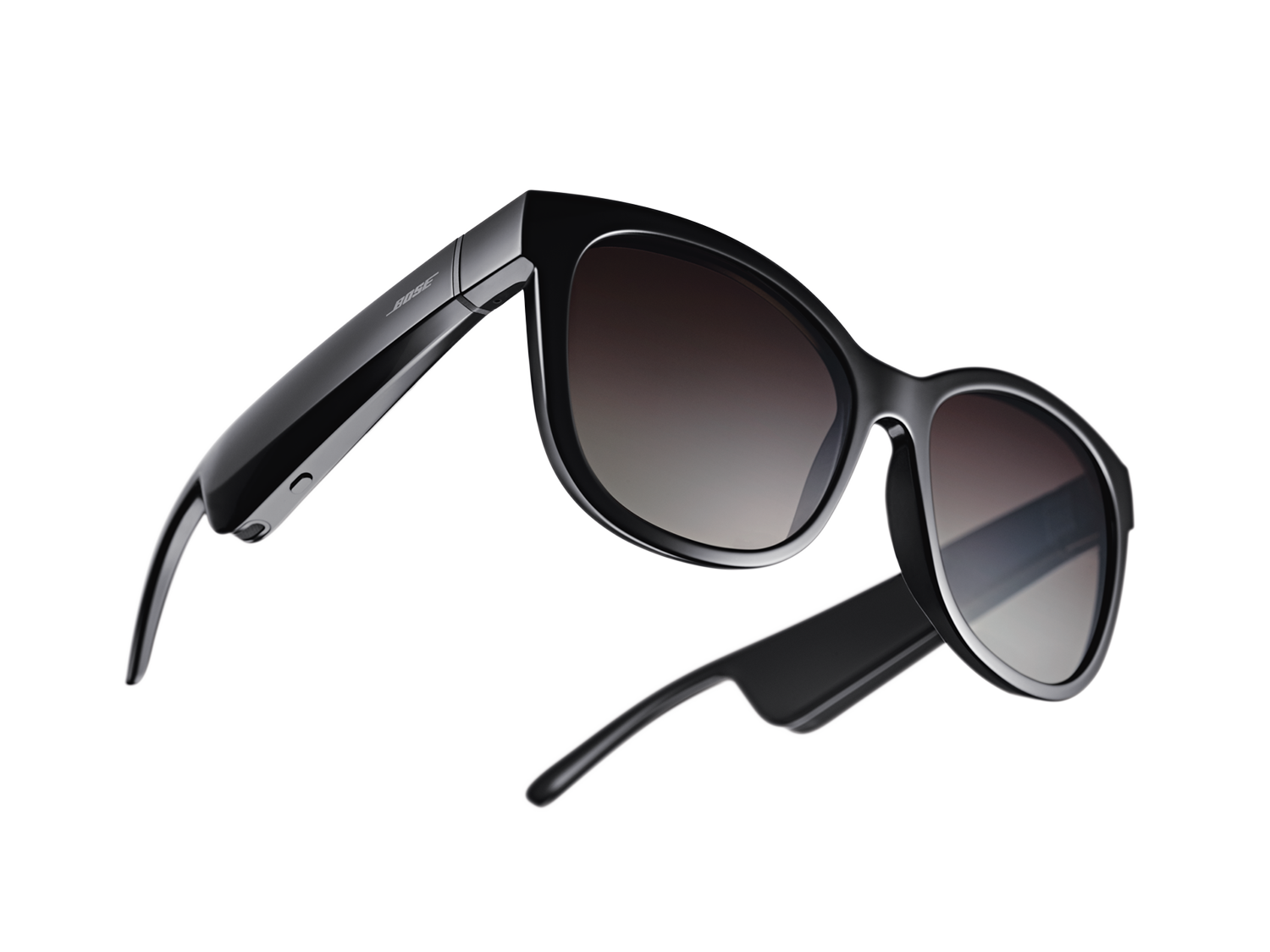 Black sunglasses with dark gradient lenses. The frame is thick and curved with the Bose logo on the side.